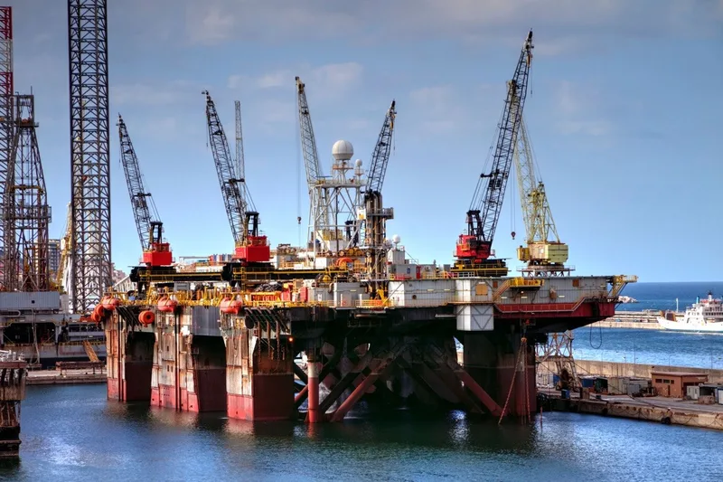 Semi-submersible offshore platforms moored in a harbour.
