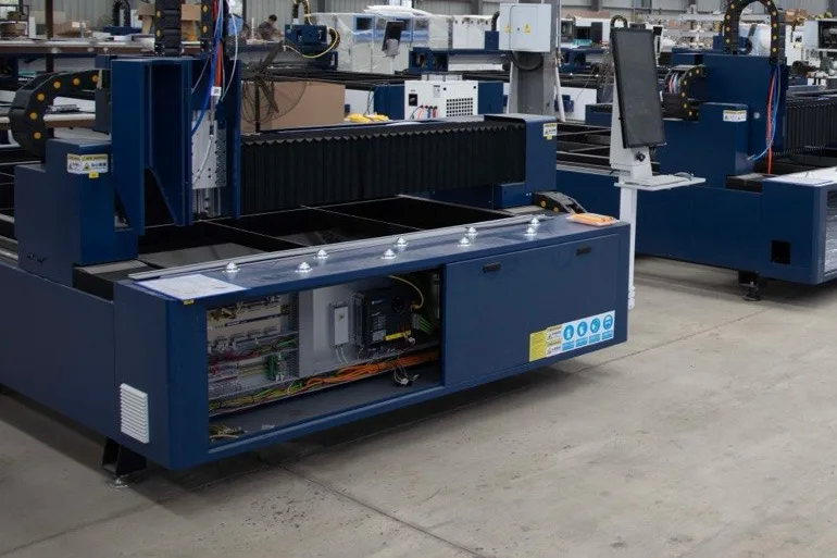 Rows of blue fabrication machines on a factory floor.